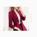 Elegant two-piece unlined blazer and A-line skirt suit in burgundy for women.