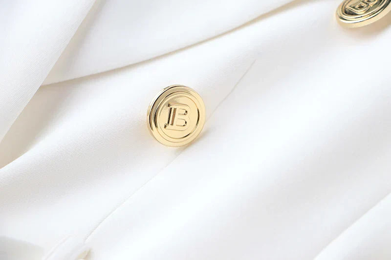 Close-up of luxury quality white office blazer with gold buttons, classic style for women.