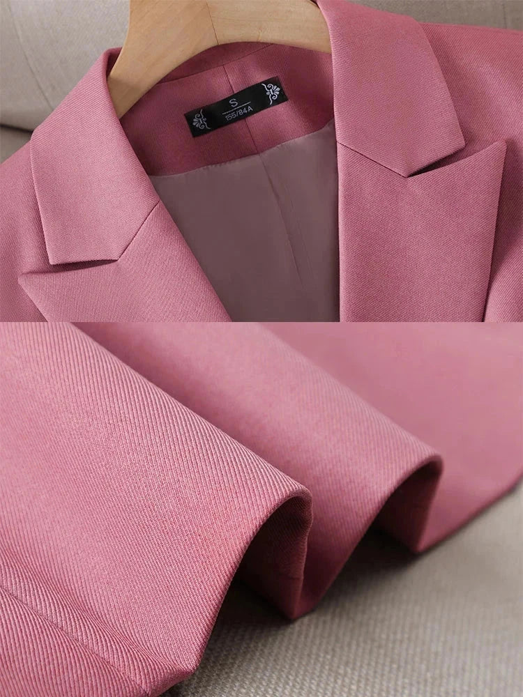 Pink long sleeve women's blazer with notched collar, triple-breasted closure, and straight fit design.