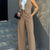 Women's casual slim notched blazer pant set with sleeveless waistcoat and high waist ankle-length pants.