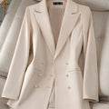 Women's beige long sleeve triple-breasted blazer with notched collar.