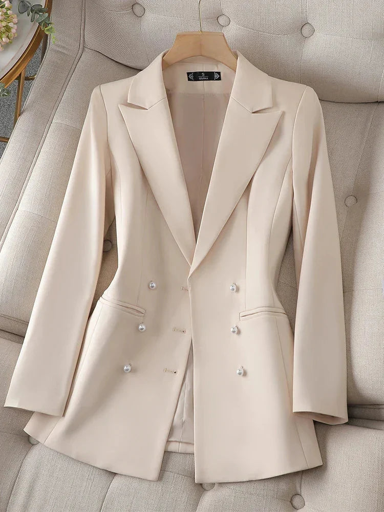 Women's beige long sleeve triple-breasted blazer with notched collar.