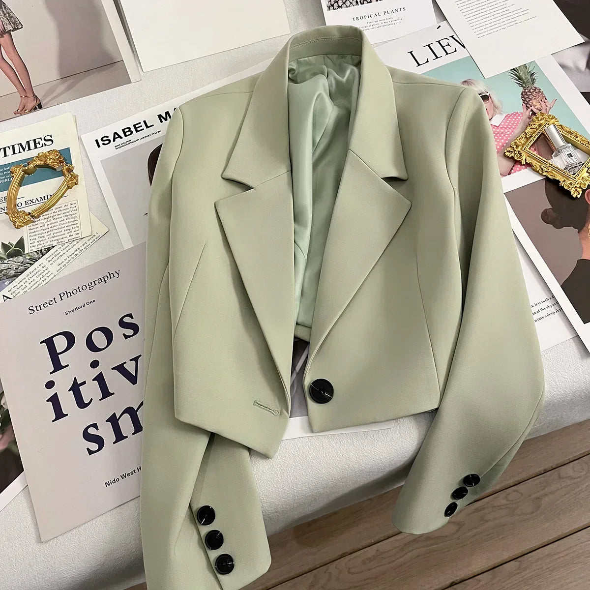 Women's loose solid color short suit jacket with notched collar and single button closure, ideal for spring and fall fashion.