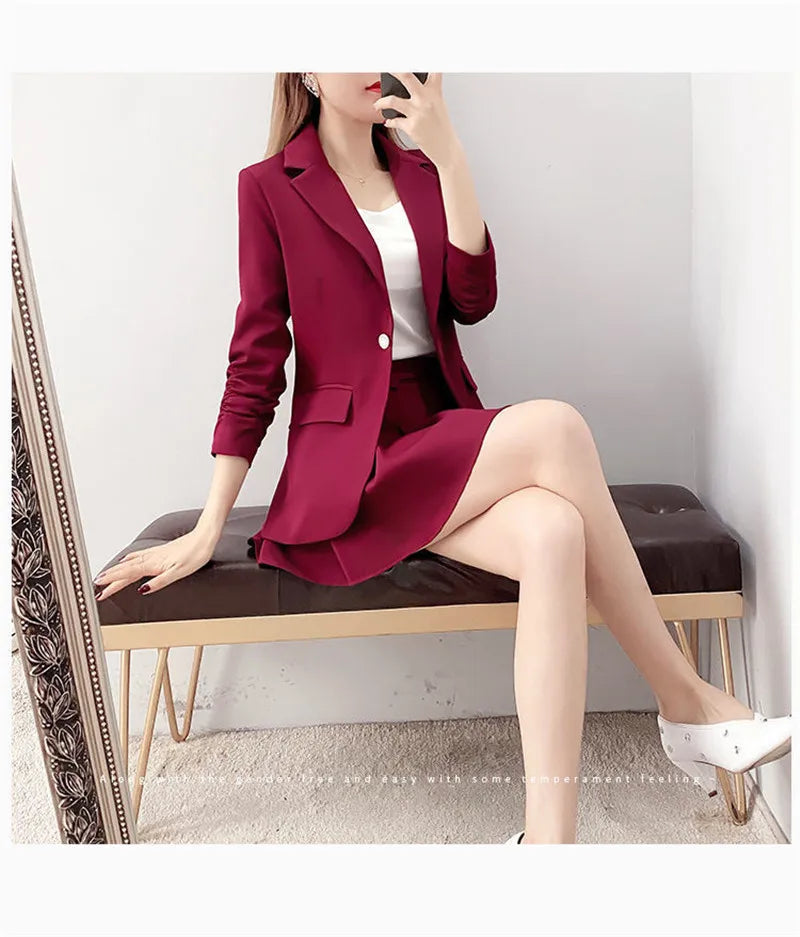 Elegant red two-piece women's suit with unlined blazer and A-line skirt, featuring a single-button closure and vintage style.