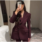 Elegant women's black suit jacket with slim lapel and single button design.