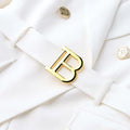 Luxury white blazer with gold buttons and buckle detail, classic style for women.