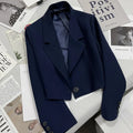 Women's loose solid color short suit jacket with notched collar and single button closure.