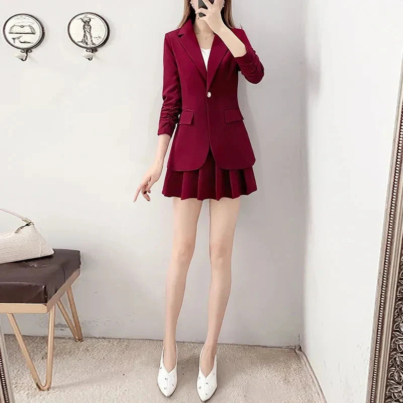 Elegant two-piece women's suit with unlined blazer and A-line skirt in burgundy.