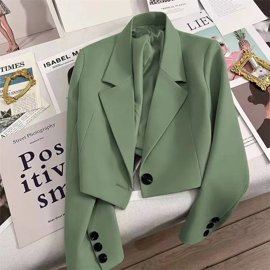 Women's loose solid color short suit jacket with a notched collar and single-button closure.