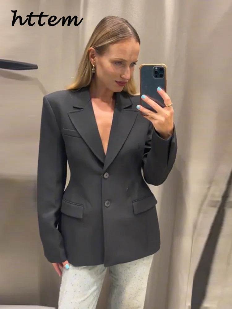 Elegant women's black blazer with slim lapel and single button, ideal for office wear.