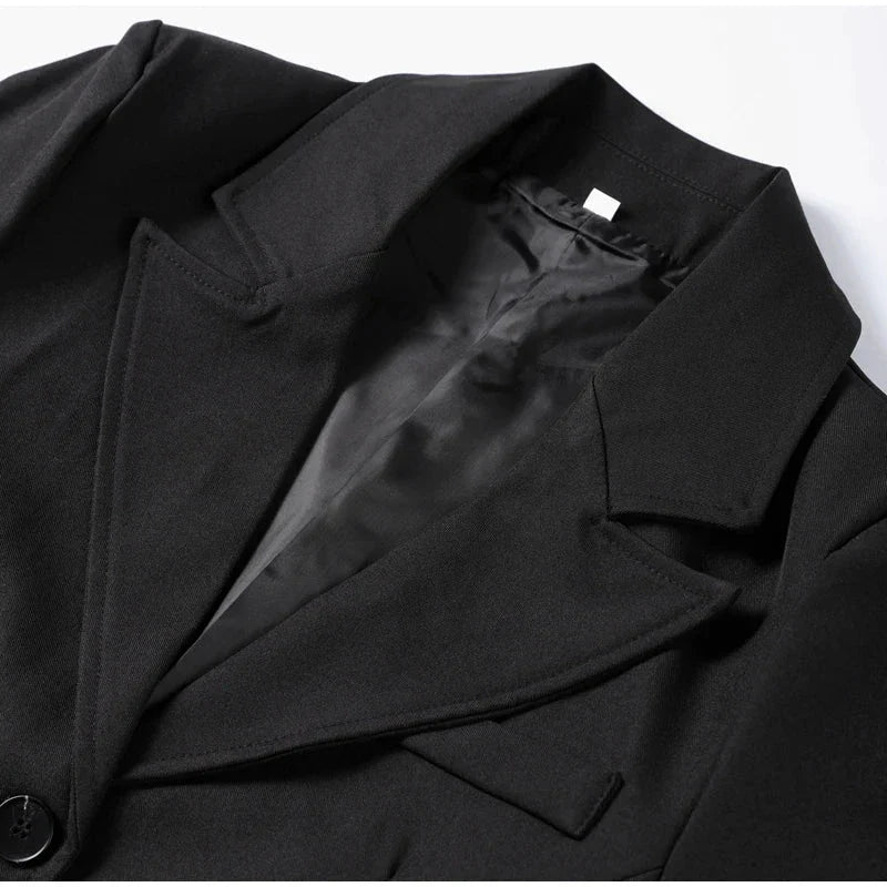 Elegant women's black suit jacket with slim lapel and single button, ideal for office wear.