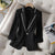 Women's black blazer with sequins, single button closure, and notched collar, perfect for summer.