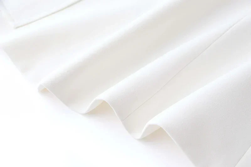 Luxury white blazer fabric with smooth texture.