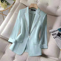 Women's white blazer with sequins, notched collar, single button closure, slim fit.