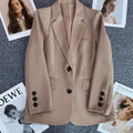 Elegant women's long sleeve blazer with button details, chic office style.