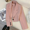 Women's loose solid color short suit jacket with notched collar and single button closure.