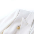 Luxury white women's pocket blazer with notched collar and double-breasted closure.