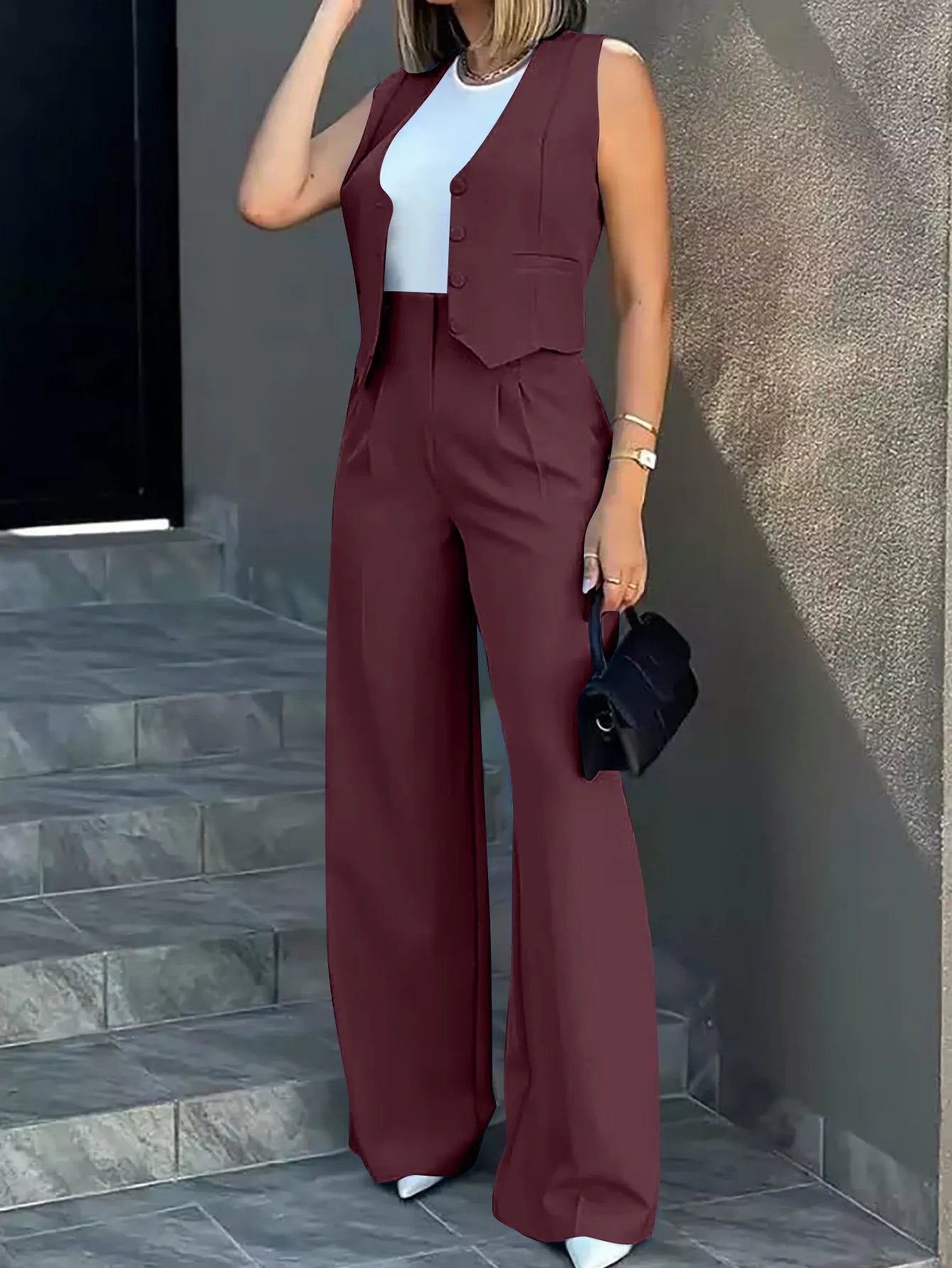 Blazer pant set with sleeveless notched cardigan and high-waisted wide-leg pants in solid color.