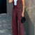 Blazer pant set with sleeveless notched cardigan and high-waisted wide-leg pants in solid color.